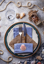 Marine Style Table Setting With Sea Shells, Fishnet And Rope