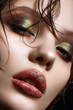 © iulskaya_photo - A young girl with bright creative makeup and perfect skin. Beautiful model with wet hair on face. Beauty of the face. Close-up portrait.