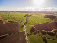 Aerial View Of A Country Road With Beautiful Agricultural Fields Under Blue Sky At Late Afternoon - Germany