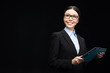© LIGHTFIELD STUDIOS - brunette businesswoman in black suit using digital tablet isolated on black
