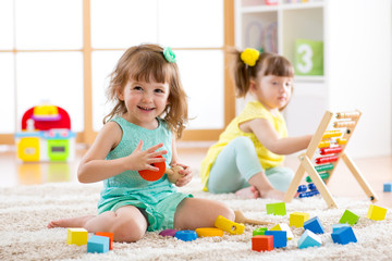 adorable children playing colorful toys