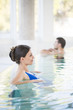 Beautiful brown woman relaxing in thalassotherapy thermal water