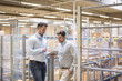 © Westend61 - Two men in factory warehouse looking at tablet