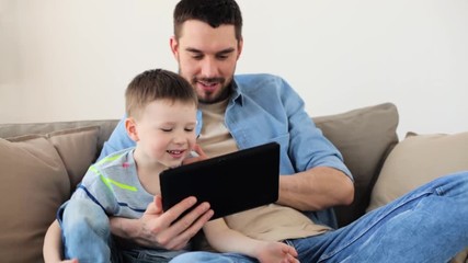 Poster - father and son with tablet pc playing at home