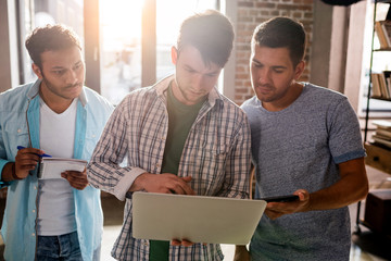 young professionals working on new business project with laptop in small business office