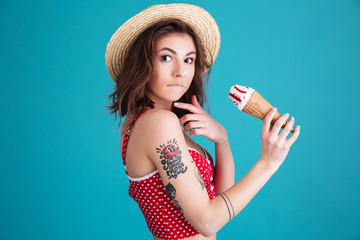 Wall Mural - Amazing young woman with ice-cream looking at camera