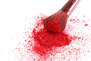 makeup brush background with blush sprinkled on white