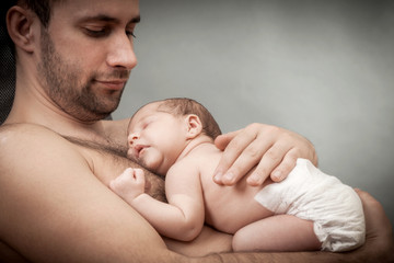 newborn child and father