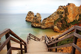 Fototapeta Morze - A wooden staircase in the azure sea. Evora. Portugal - beautiful backgound