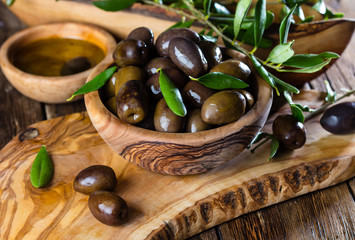 Olives and olive oil in olive wooden bowls