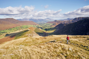 Poster - A hiker walking down towards High Snab Bank from the summit of Robinson in the Lake District, England, UK.