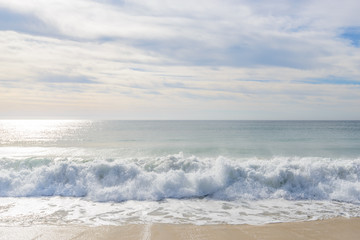 Set of pictures of a fantastic ocean wave in different stages. Cloudy sunrise sky. San Jose del Cabo. Mexico.