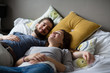 © ReeldealHD images - Young couple relaxing in bed
