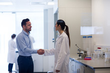 Female Scientist Shaking Hands With Pharmaceutical Sales Rep