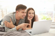 © Africa Studio - Happy young couple with laptop at home