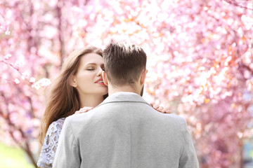 Canvas Print - Young lovely couple walking in spring park