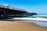 Fototapeta Morze - Pacific Beach in San Diego, California with vacation cottages on top of Crystal Pier.