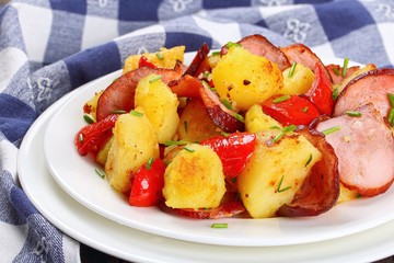 Canvas Print - tasty roasted potato wedges with sausages