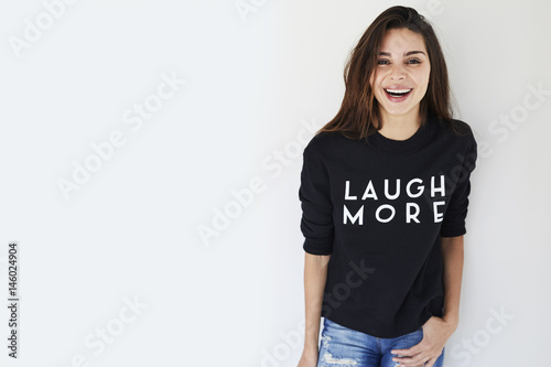 Fotografiet Laughing brunette in slogan sweatshirt, portrait