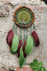 Wall Mural - Dreamcatcher made of feathers, leather, beads, and ropes