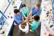 © LIGHTFIELD STUDIOS - high angle view of colleagues holding hands together