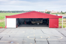 Helipad And Open Hangar With A Helicopter Inside
