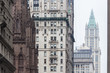 New York City, Lower Manhattan, arhitectural detail of Broadway street wiev: Trinity Church, New York City Charter School Center and Woolworth building far away.