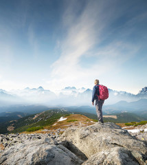 Wall Mural - mountain tourist on the high rock. sport and active life concept