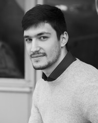 Dark Haired Man with Beard Looking at Camera