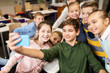 © Syda Productions - group of school kids taking selfie with smartphone