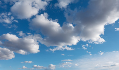 Wall Mural - White clouds flying against blue sky.