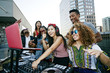 © Peathegee Inc/Blend Images - Friends posing with DJ on urban rooftop