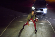 Headlights Shining On Black Man Playing Basketball