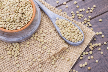 Wall Mural - Pile of lentils on wooden background (Lens culinaris)
