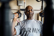 © Inti St Clair/Blend Images - Black man lifting weights in garage
