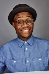 Wall Mural - attractive young black male studio with hat cheesy smile