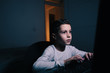 © kleberpicui - Little boy using computer at night in bedroom