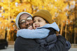 © Roberto Westbrook/Blend Images - Father and son hugging in park