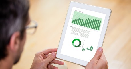 Poster - Cropped image of businessman reviewing graphs on tablet PC