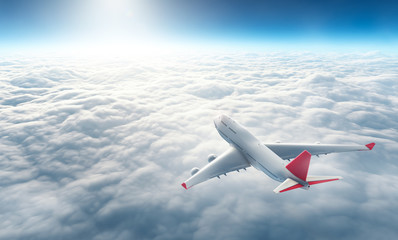 Wall Mural - airplane flying above clouds