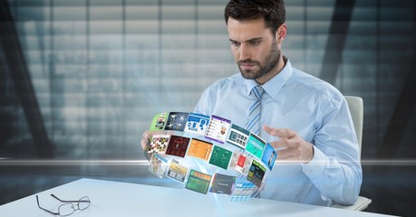 Wall Mural - Businessman looking at panels spinning on desk