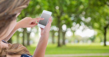 Poster - Cropped image of hand using smart phone at park