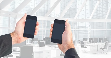 Poster - Cropped image of hands holding smart phones in office