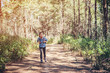 © Lealnard - Young girl walking in pine forset for go to target.