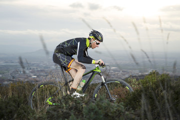 Wall Mural - Cyclist man riding mountain bike on mountain.