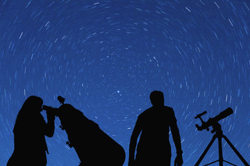 Wall Mural - couple looking at the stars with telescopes.