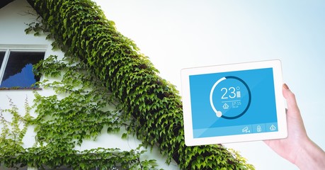 Poster - Hand using smart home application on tablet PC outside house