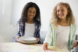 © JGI/Jamie Grill/Blend Images - Girls setting the table for meal