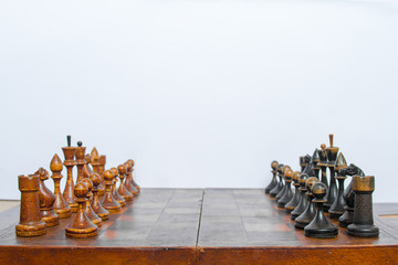 Old chess Board with wooden pieces.