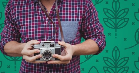 Poster - Man mid section with camera against green nature pattern